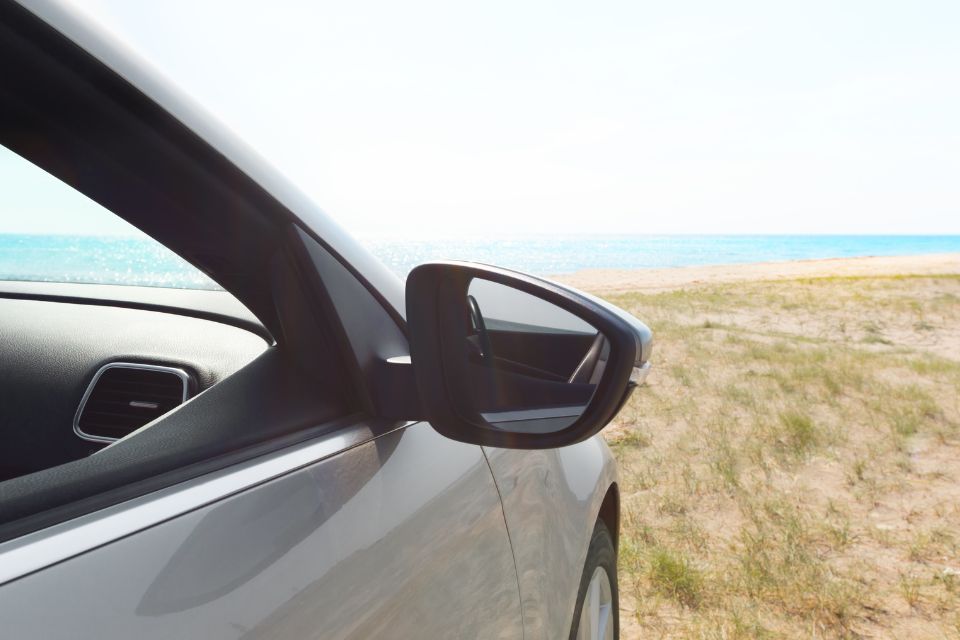 Lateral de carro numa zona alta com o mar à frente, para retratar o tema dos cuidados com o carro no verão